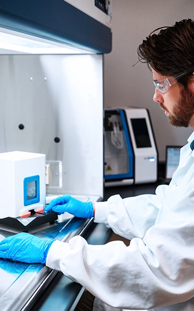 Researcher at BioCina working on advanced modalities and complex therapy development in a controlled laboratory setting.