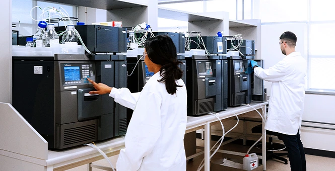 Laboratory team utilizing high-performance liquid chromatography for analytical development and biologics testing.