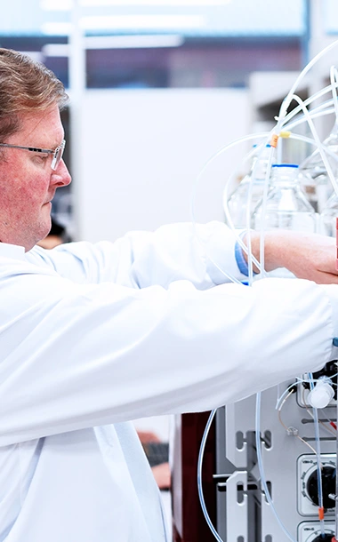 BioCina expert setting up bioprocess development equipment to optimize clinical batch production for partners.