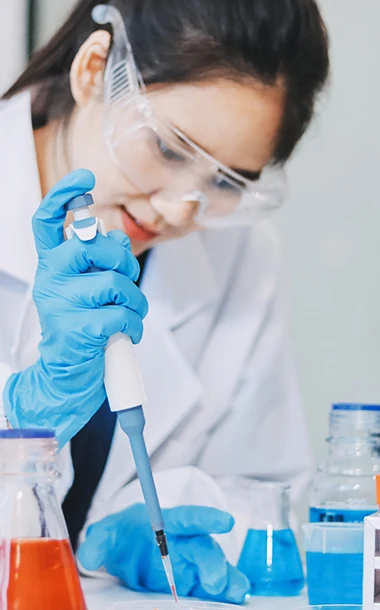 Scientist using a precision pipette for analytical development and bioassay testing in a BioCina laboratory.