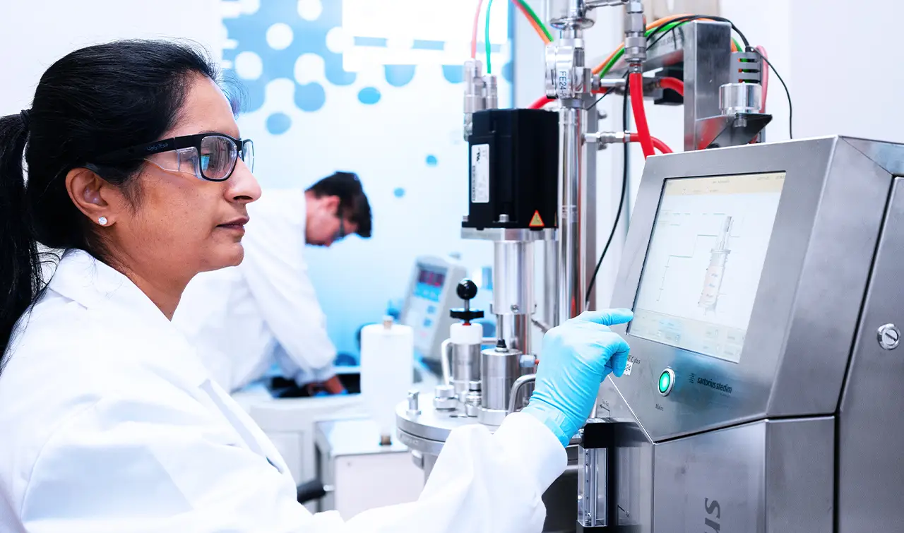BioCina scientist operating a Sartorius Biostat C Plus 20L fermenter for microbial process development.